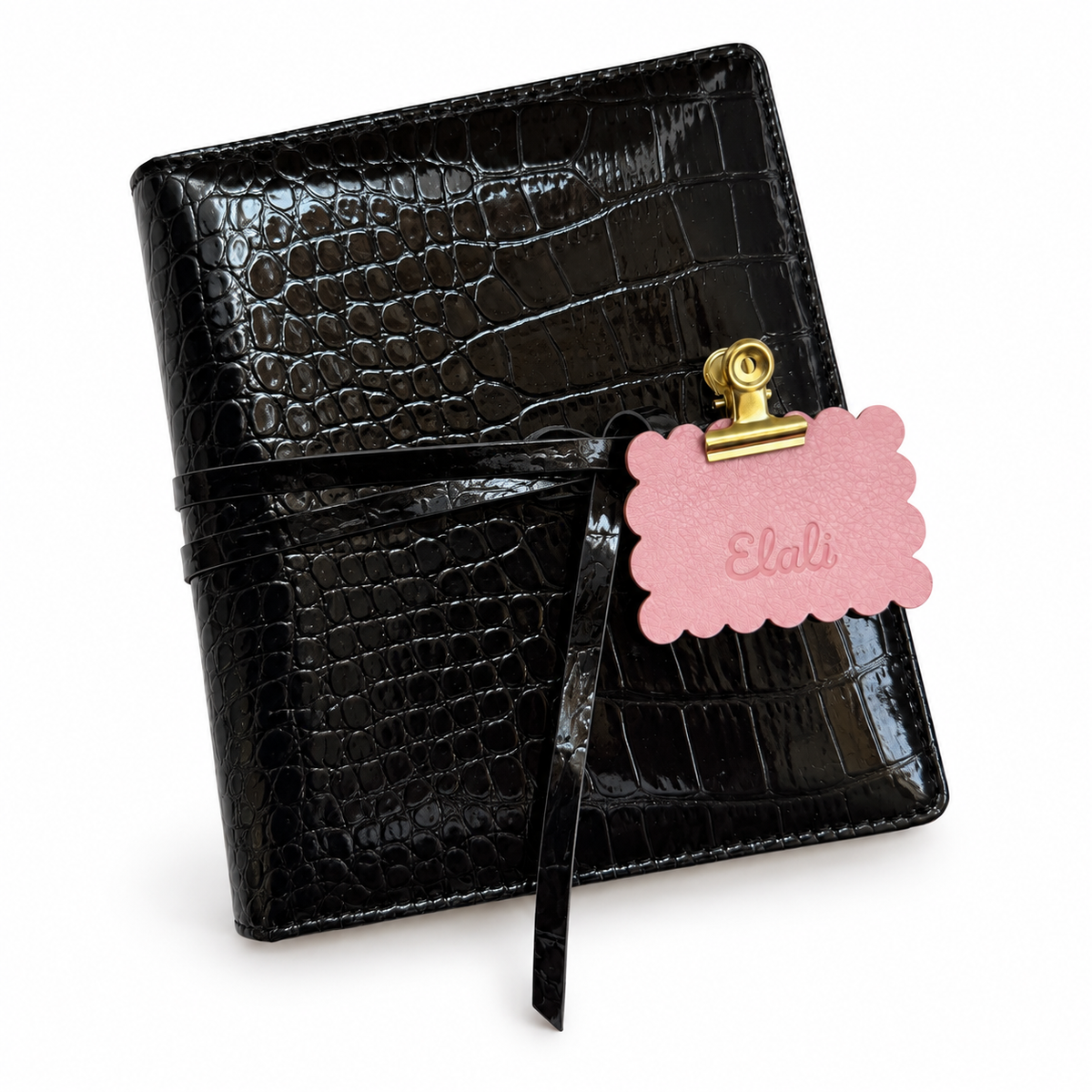 Black croc embossed Elali journal with wrap tie and pink Elali keepsake tag on white background, no optional charms