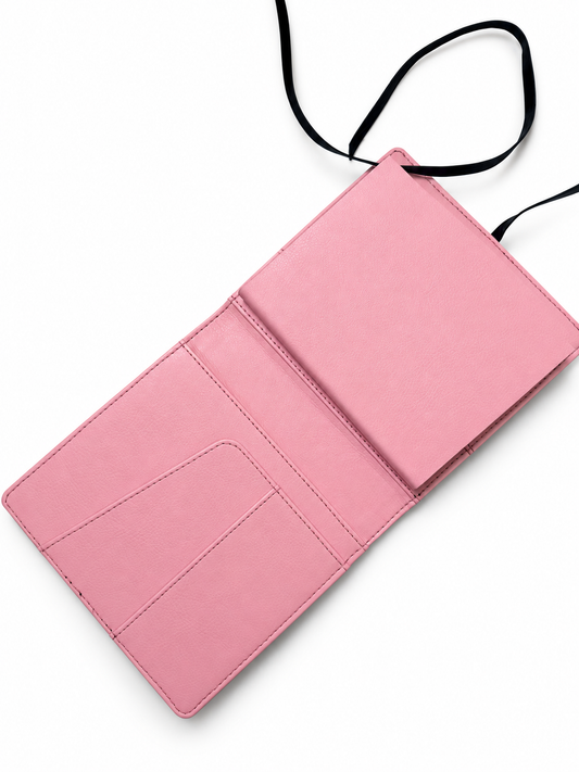 Pale pink interior of the Elali journal, open with left pockets and empty right sleeve on white background