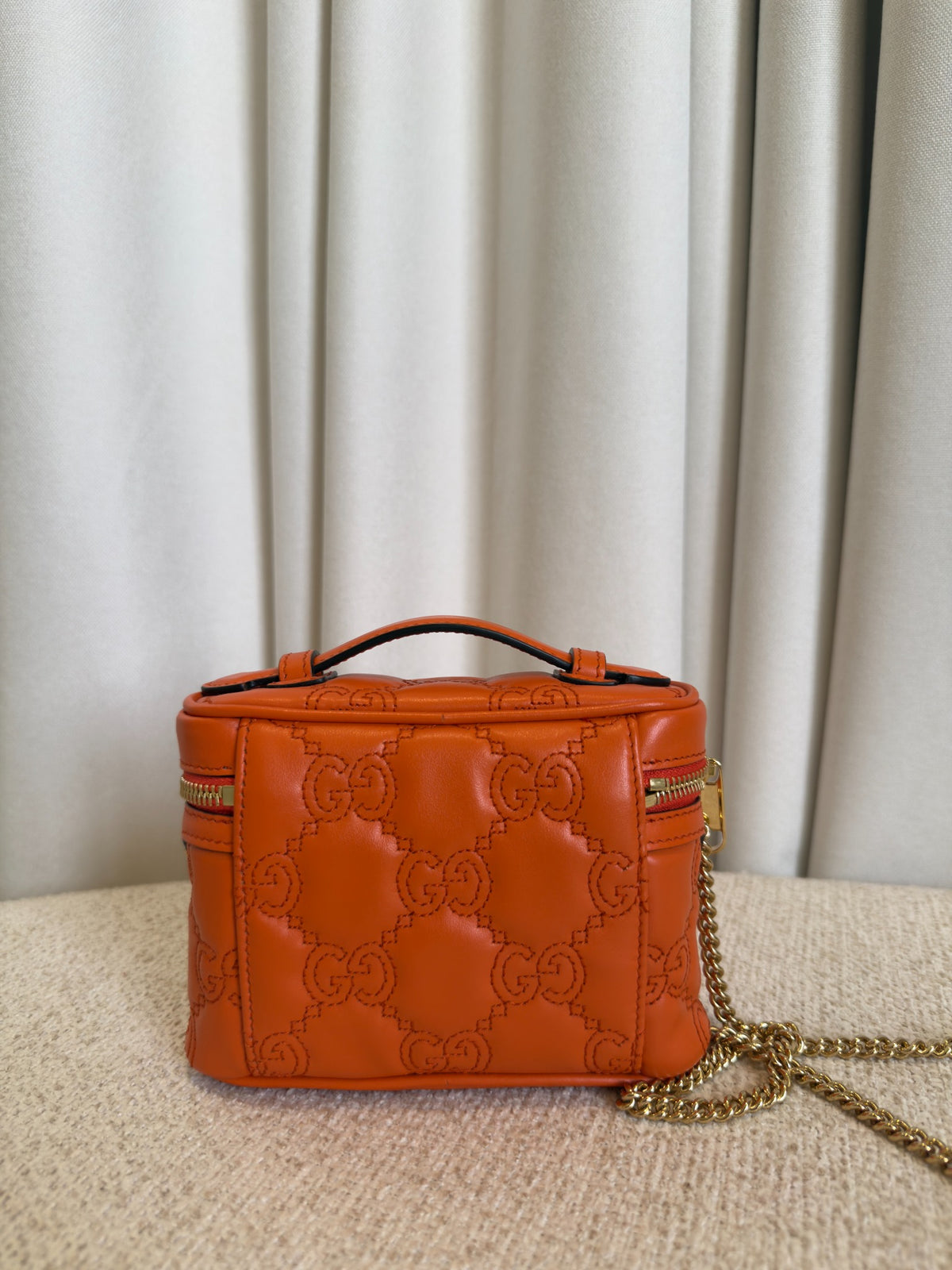 Gucci GG Marmont orange mini vanity case back view