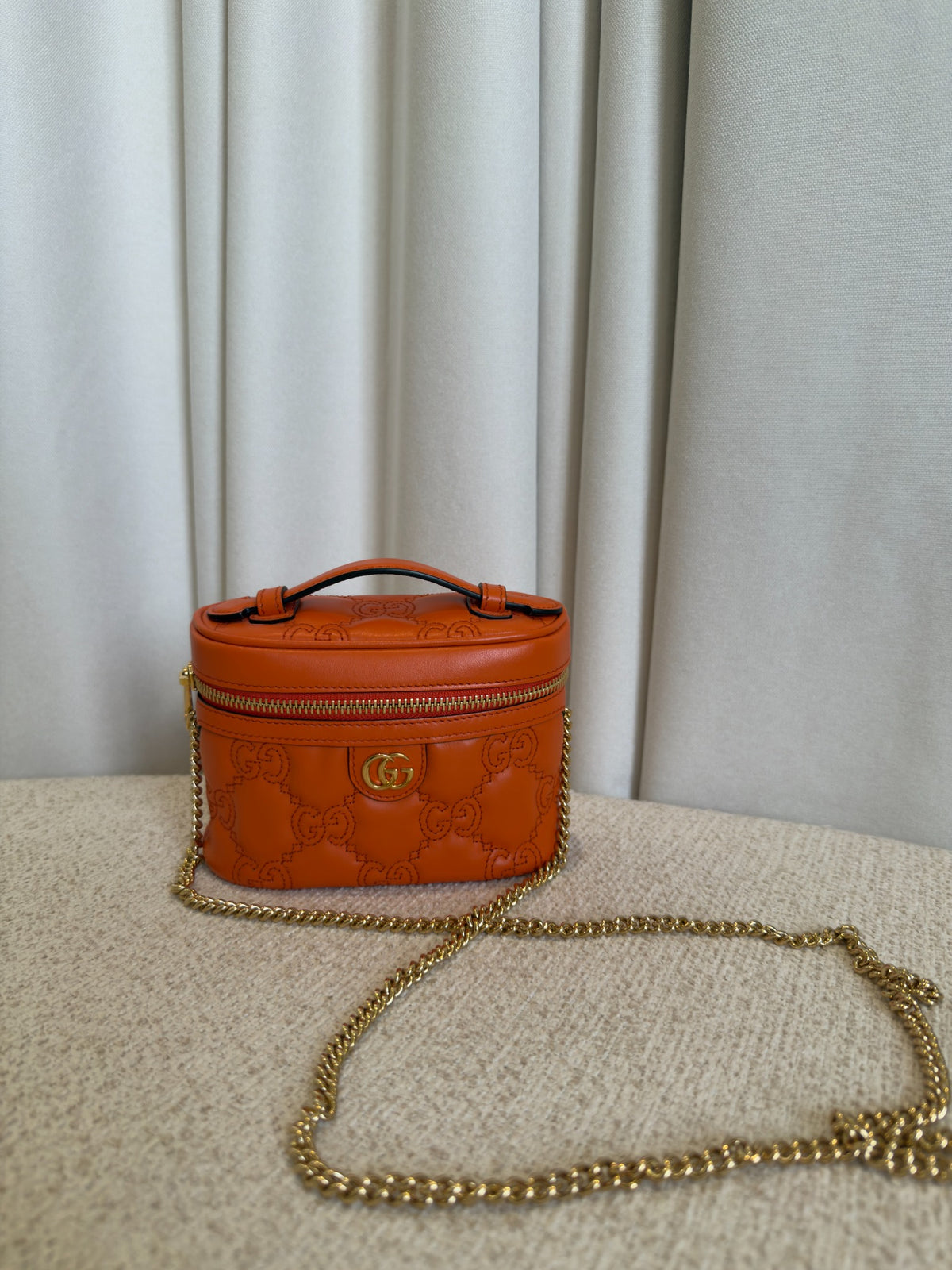 Gucci GG Marmont orange mini vanity case front view with chain