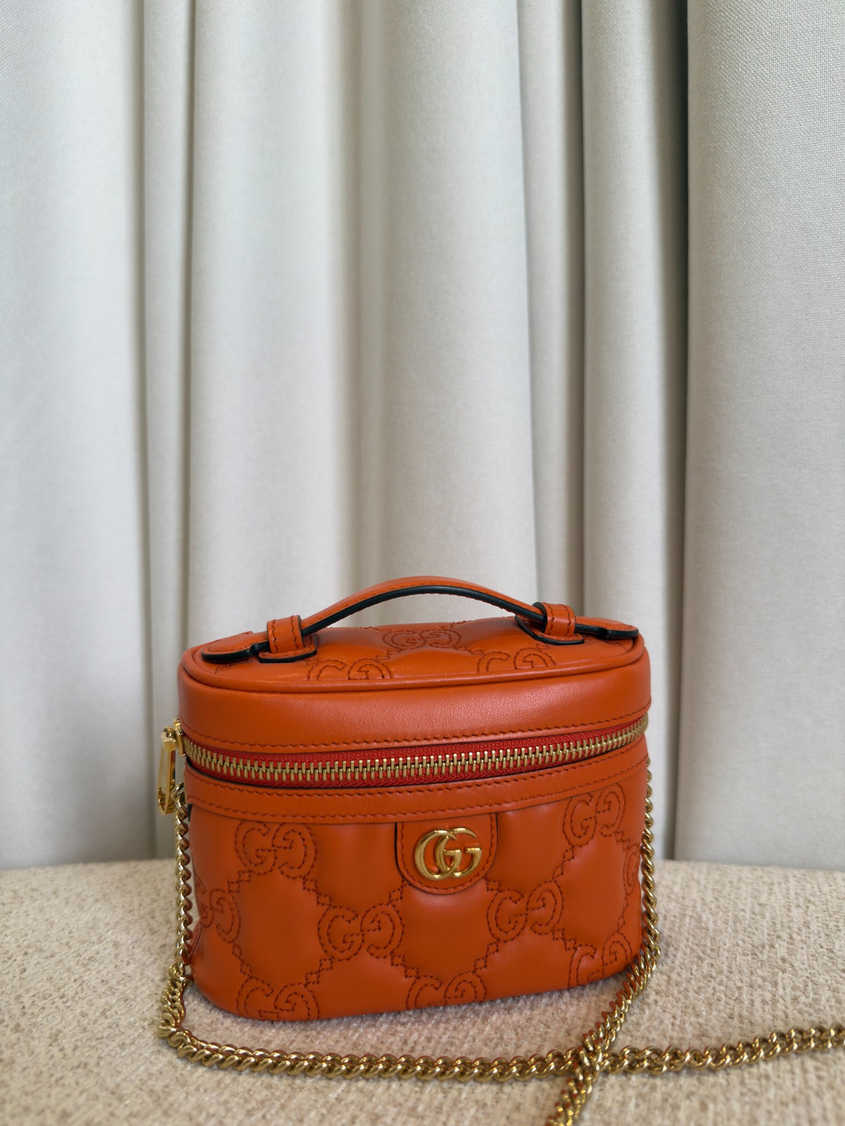 Gucci GG Marmont orange mini vanity case front close-up