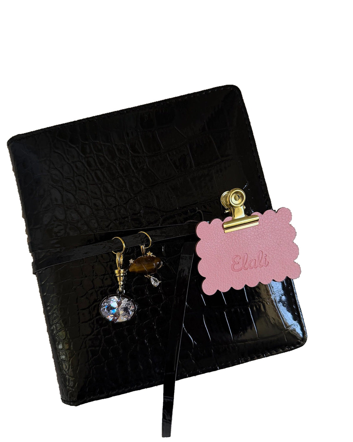 Elali croc journal with clear oval and brown charms and pink Elali keepsake tag on a clean white background