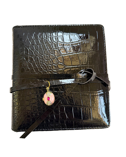 Elali croc journal with pink locket charm on a clean white background